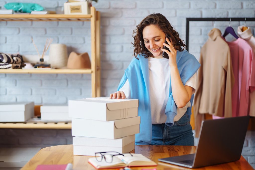 Small business owner, entrepreneur, seller using tablet checking ecommerce clothing store orders.